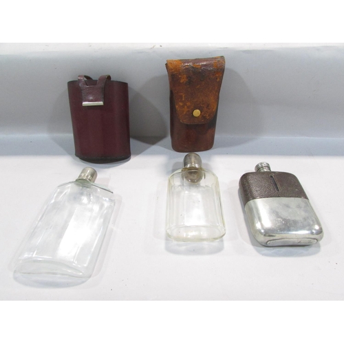 512 - Three hip flasks, an antique 12 bore cartridge crimper, and two antique powder flasks.