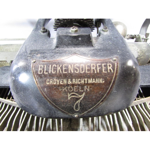 523 - A distressed vintage Blickensderfer No 7 typewriter, a wooden desk top adjustable calendar , a vinta... 