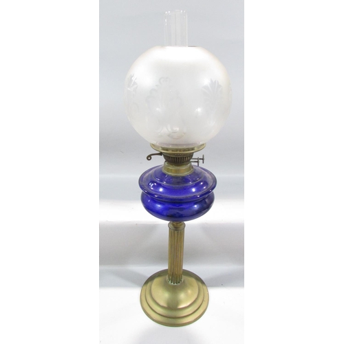 546 - A 19th century brass column oil lamp with a blue glass font and opaque decorative shade.