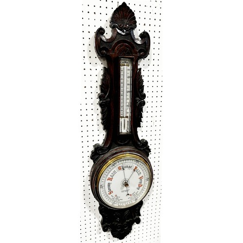 463 - An Edwardian aneroid barometer with carved oak case, porcelain dials with coloured detail by A & R R... 