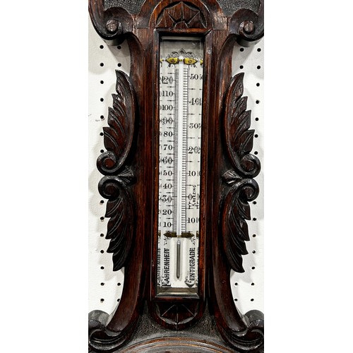 463 - An Edwardian aneroid barometer with carved oak case, porcelain dials with coloured detail by A & R R... 