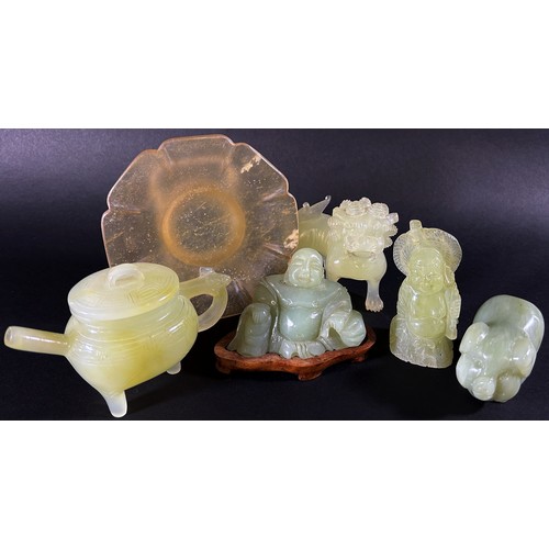 212 - A collection of Chinese pale celadon coloured bowenite jade carvings to include a pierced group deta... 