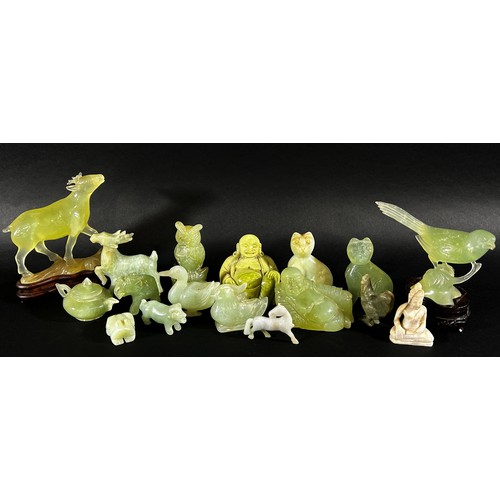 215 - A collection of Chinese carved bowenite jade, pink quartz and other hardstone animals, to include ma... 