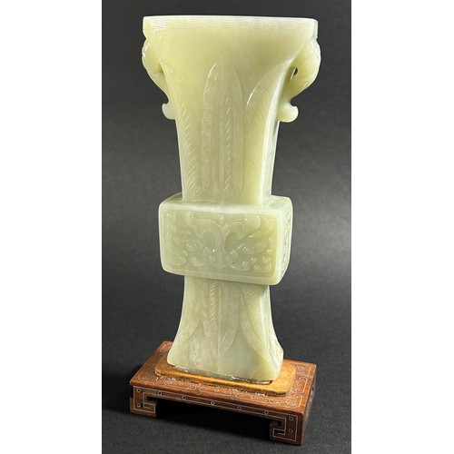 214 - A Chinese archaistic style carved pale mutton fat jade / hardstone vase, of tapering flared form, ca... 