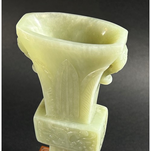 214 - A Chinese archaistic style carved pale mutton fat jade / hardstone vase, of tapering flared form, ca... 