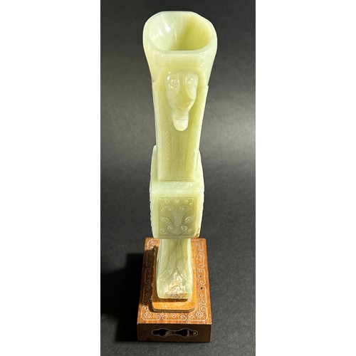 214 - A Chinese archaistic style carved pale mutton fat jade / hardstone vase, of tapering flared form, ca... 