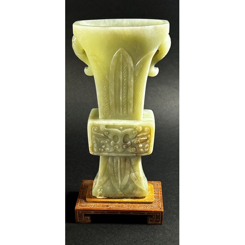 214 - A Chinese archaistic style carved pale mutton fat jade / hardstone vase, of tapering flared form, ca... 