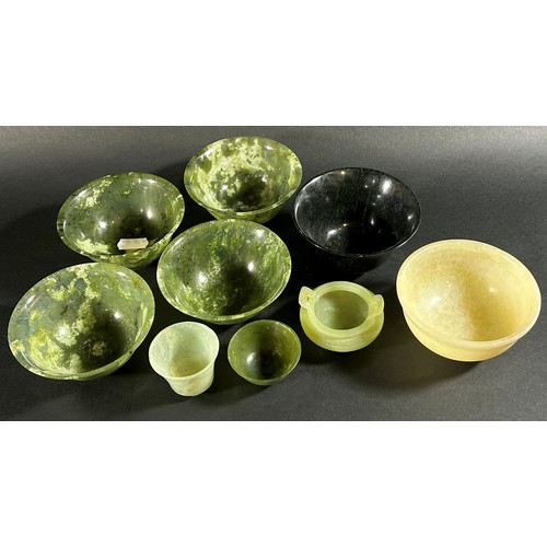 220 - A collection of Chinese bowenite jade / hardstone bowls pf varying size / form to include a matched ... 