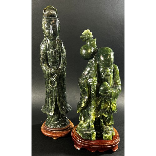 228 - A large Chinese carved green jadeite figure of Guanyin, raised on fixed hardwood stand, 41cm high, t... 