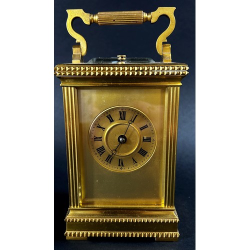 450 - A 19th century brass French carriage clock, the case with reeded and decorative borders, with eight ... 