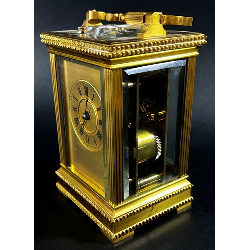 450 - A 19th century brass French carriage clock, the case with reeded and decorative borders, with eight ... 