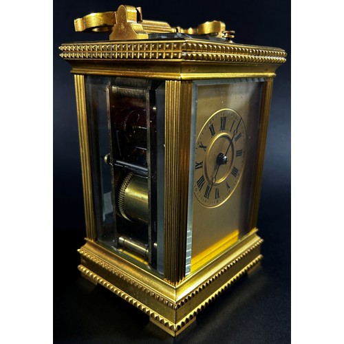 450 - A 19th century brass French carriage clock, the case with reeded and decorative borders, with eight ... 