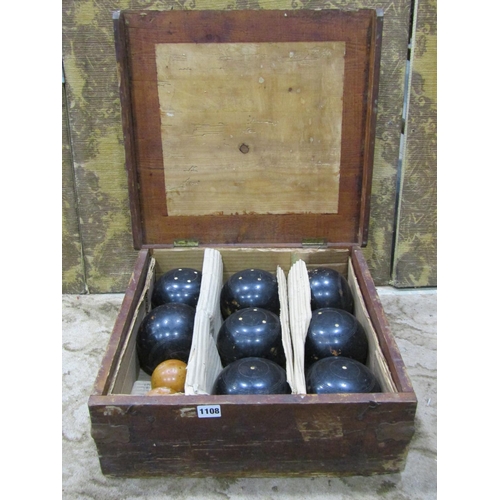 1108 - A cased set of lawn bowls, 8 large balls in ebony together with two smaller boxwood examples