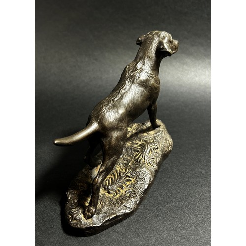 541 - A small bronze recumbent whippet, 21cm from nose to tail (base length) together  with a bronzed resi... 