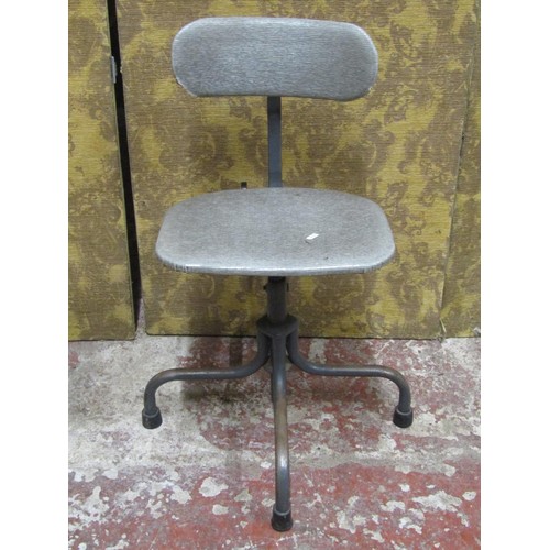 1129 - A vintage industrial office chair with adjustable base, raised on tubular supports