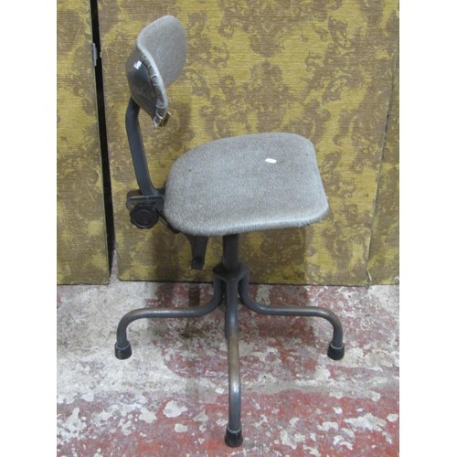 1129 - A vintage industrial office chair with adjustable base, raised on tubular supports