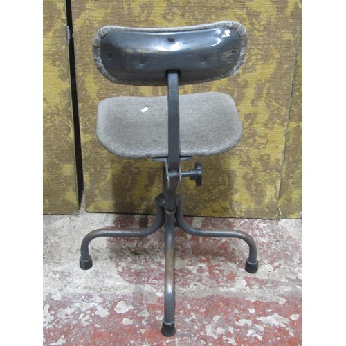 1129 - A vintage industrial office chair with adjustable base, raised on tubular supports