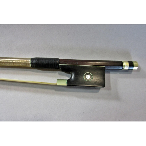 551 - A violin bow stamped Pecatte above both sides of the Frog with a mother-of-pearl eye, 75 cm long