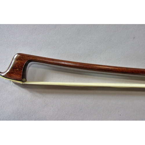 551 - A violin bow stamped Pecatte above both sides of the Frog with a mother-of-pearl eye, 75 cm long