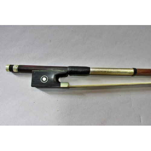 551 - A violin bow stamped Pecatte above both sides of the Frog with a mother-of-pearl eye, 75 cm long