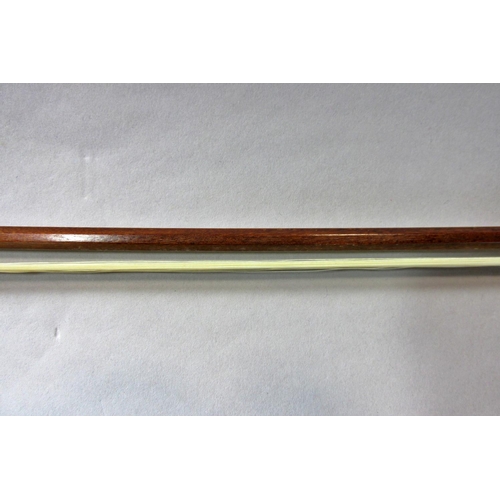 551 - A violin bow stamped Pecatte above both sides of the Frog with a mother-of-pearl eye, 75 cm long