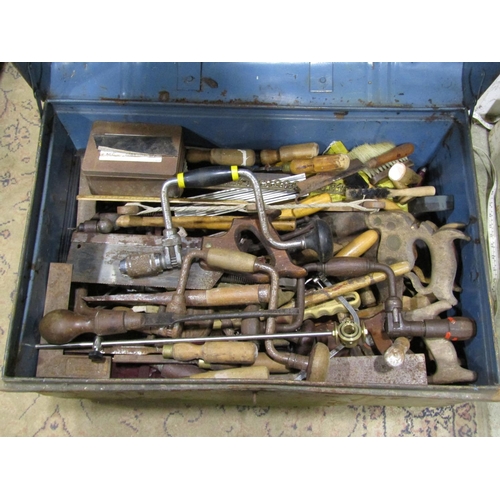 1083 - A steel trunk containing a good miscellaneous selection of hand tools, braces, bits, handsaws, chise... 