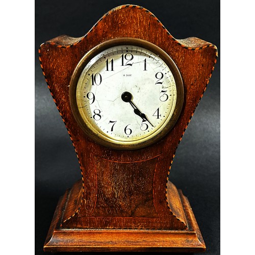 438 - An Edwardian mahogany mantle clock with shaped outline, chequered string borders and eight day timep... 