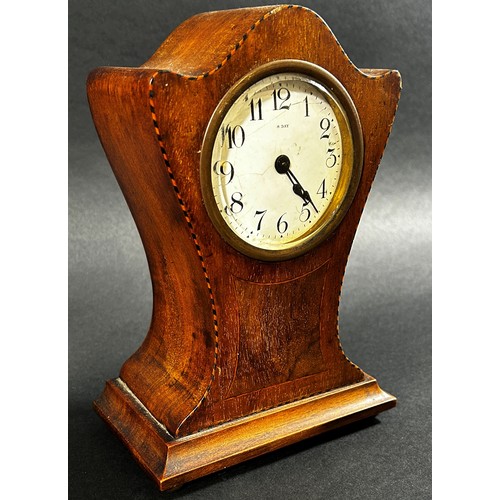 438 - An Edwardian mahogany mantle clock with shaped outline, chequered string borders and eight day timep... 