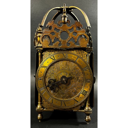 436 - An antique lantern clock of traditional form, the brass dial with engraved detail, with chased inner... 