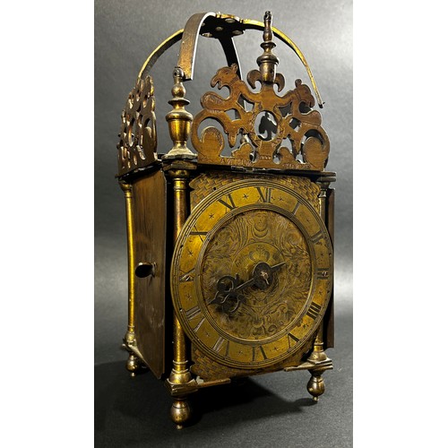 436 - An antique lantern clock of traditional form, the brass dial with engraved detail, with chased inner... 