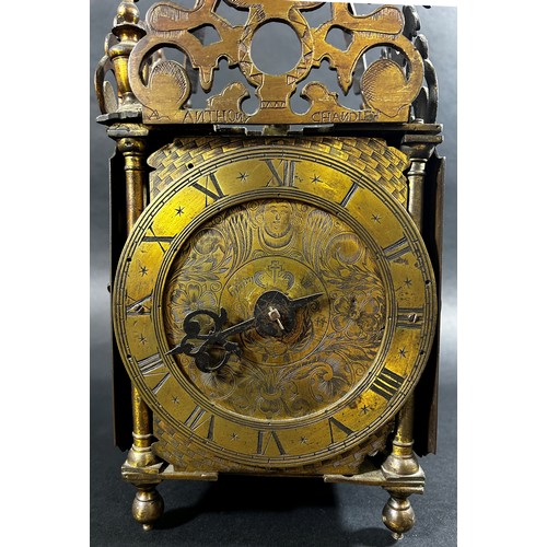 436 - An antique lantern clock of traditional form, the brass dial with engraved detail, with chased inner... 