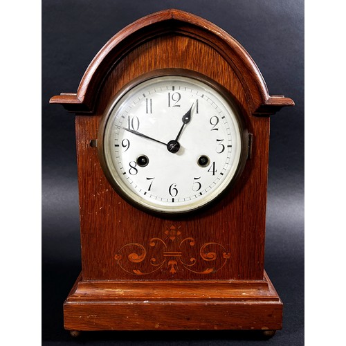 435 - Edwardian oak lancet shaped mantle clock, the case with marquetry inlay, with eight day striking mov... 