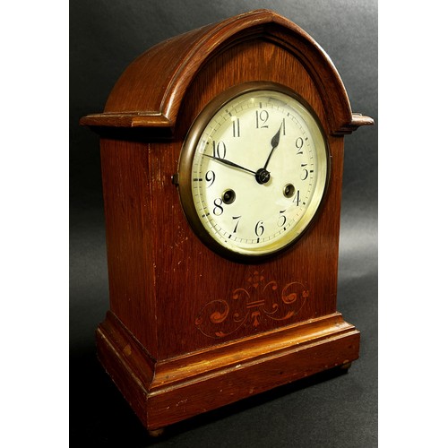 435 - Edwardian oak lancet shaped mantle clock, the case with marquetry inlay, with eight day striking mov... 