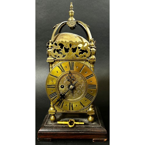 451 - A small 19th century lantern clock of usual form with single train fusee movement, set on a square c... 