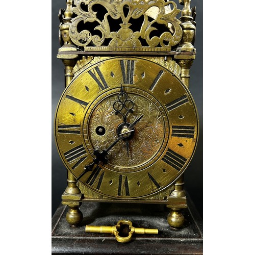 451 - A small 19th century lantern clock of usual form with single train fusee movement, set on a square c... 