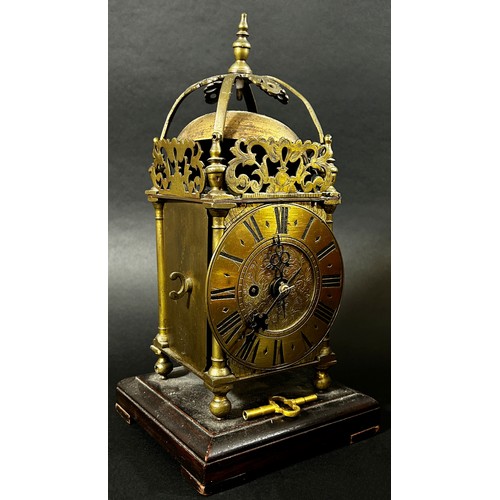 451 - A small 19th century lantern clock of usual form with single train fusee movement, set on a square c... 