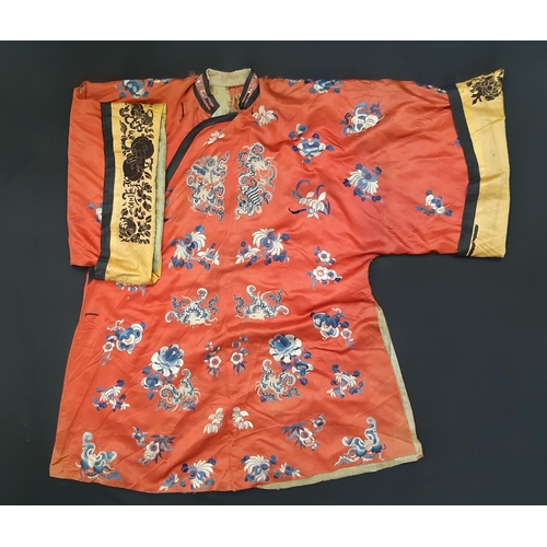 881 - A late 19th/ early 20th century Chinese robe of red silk embroidered with flowers, moths and other s... 