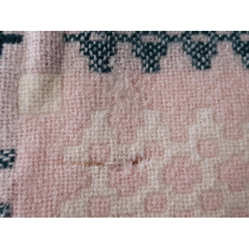 882 - A traditional woollen Welsh blanket of reversible double weave in pink, green, white and cream colou... 