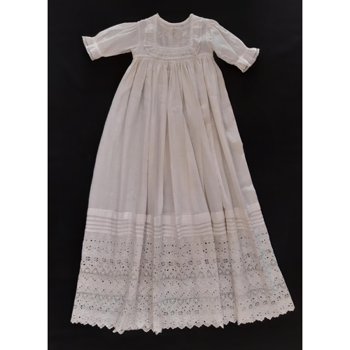 884 - Five early 20th century baby garments including a cream woollen carry shawl with embroidered yoke an... 