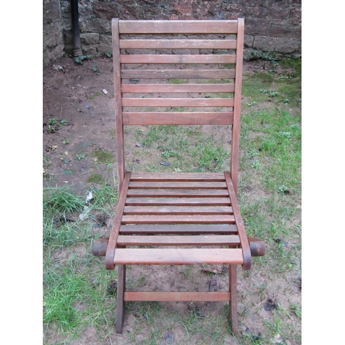 1035 - A weathered contemporary teak garden table of oval form with slatted top, raised on X framed support... 