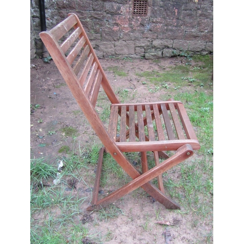 1035 - A weathered contemporary teak garden table of oval form with slatted top, raised on X framed support... 