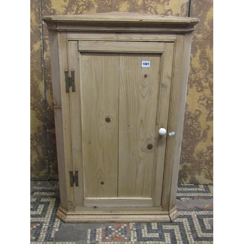 1081 - A stripped and waxed pine hanging corner cupboard with panelled door, a flight of open shelves and a... 