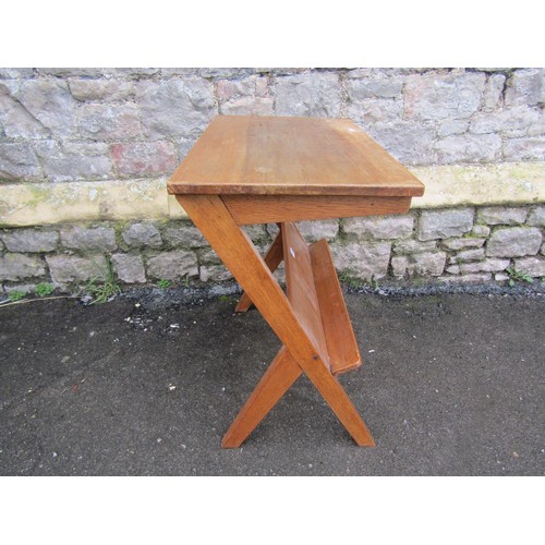 1181 - Mid 20th century writing desk/work table of rectangular form with under shelf, raised on X framed su... 