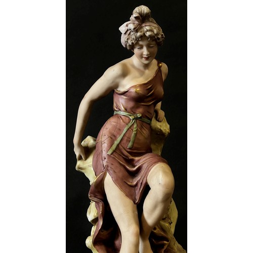 36A - Royal Dux figure of a woman seated on a rock, 44cm high (af)