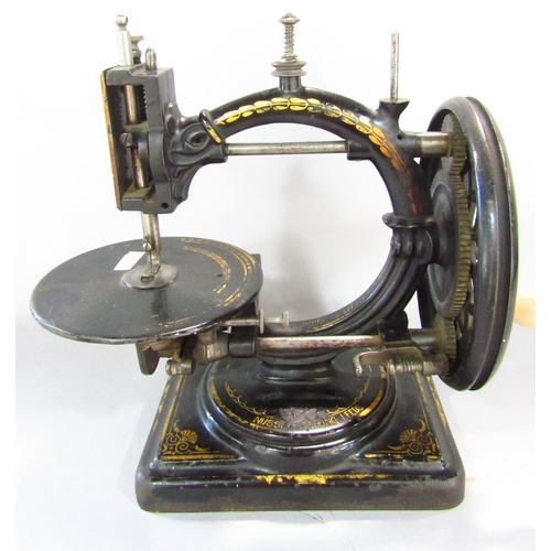 530 - A scarce Nussey & Pilling 'Little Stranger' Victorian sewing machine with gilt decoration, on metal ... 