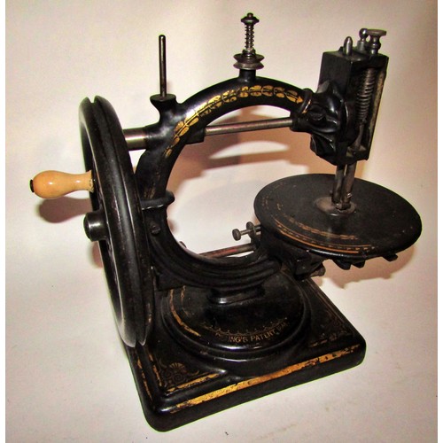 530 - A scarce Nussey & Pilling 'Little Stranger' Victorian sewing machine with gilt decoration, on metal ... 