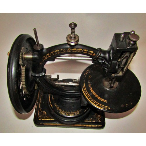 530 - A scarce Nussey & Pilling 'Little Stranger' Victorian sewing machine with gilt decoration, on metal ... 