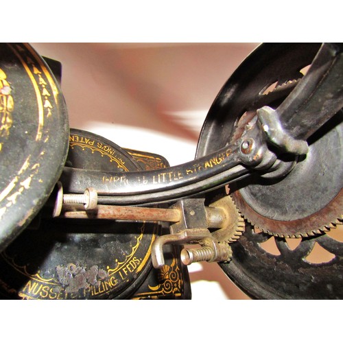 530 - A scarce Nussey & Pilling 'Little Stranger' Victorian sewing machine with gilt decoration, on metal ... 