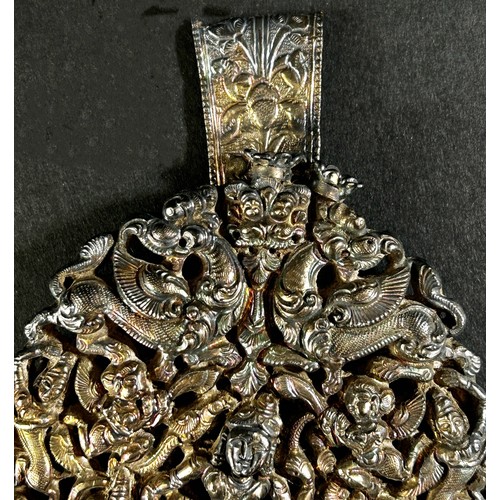 203 - A silver metal ornate Indian head dress ornament with a central dancer surrounded by figures and mys... 