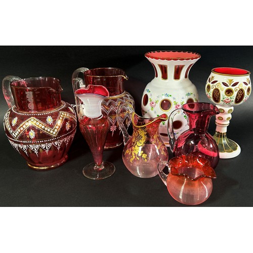 147 - A varied collection of Bohemian and Cranberry glassware, including a Bohemian glass overlay vase and... 